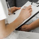 close-up-doctor-taking-notes