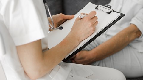 close-up-doctor-taking-notes