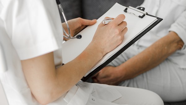 close-up-doctor-taking-notes