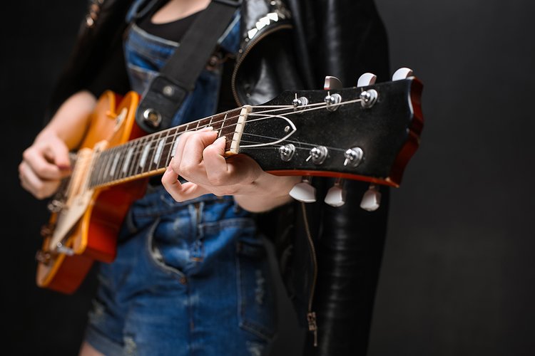 close-up-girl-s-hands-guitar-black-background
