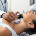 close-up-shot-young-woman-getting-her-neck-examined-by-doctor-using-ultrasound-scanner-modern-clinic