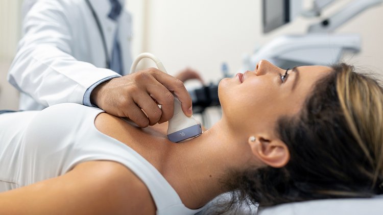 close-up-shot-young-woman-getting-her-neck-examined-by-doctor-using-ultrasound-scanner-modern-clinic