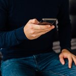 close-up-view-male-hand-using-mobile-phone