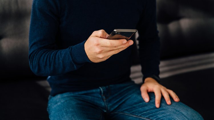 close-up-view-male-hand-using-mobile-phone