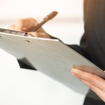 close-up-woman-writing-clipboard-with-pen
