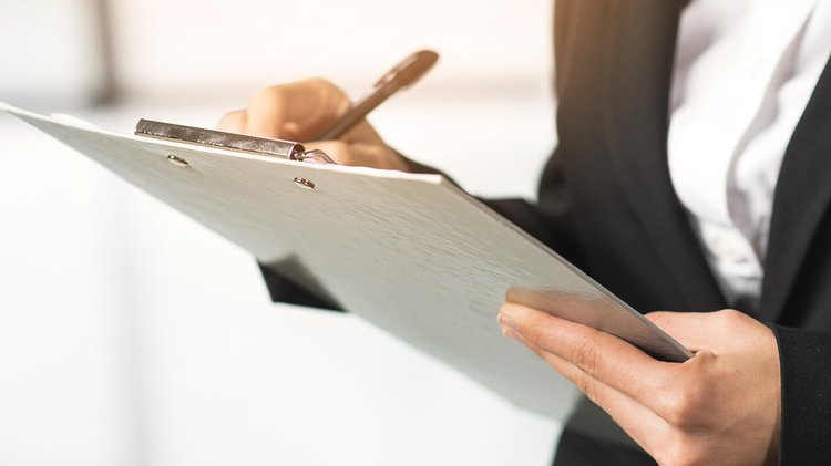 close-up-woman-writing-clipboard-with-pen