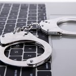 closeup-shot-handcuffs-lying-laptop-keypad-online-crime-concept