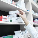 closeup-view-pharmacist-hand-taking-medicine-box-from-shelf-drug-store