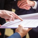 cropped-view-businesswomen-reading-document
