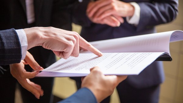 cropped-view-businesswomen-reading-document
