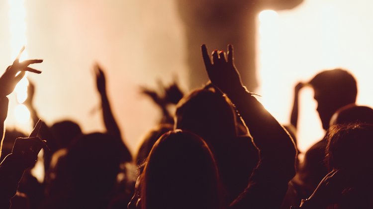 dancing-concert-while-singer-is-performing-surrounded-with-lights