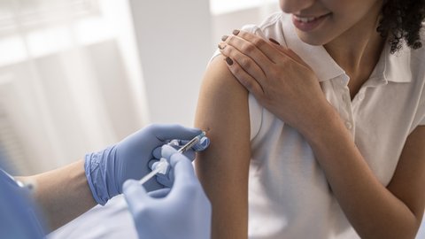 doctor-vaccinating-patient-clinic