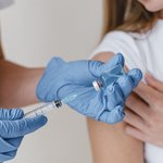 doctor-with-gloves-preparing-vaccine-woman