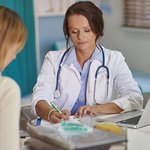 doctor-writing-prescription-her-patient