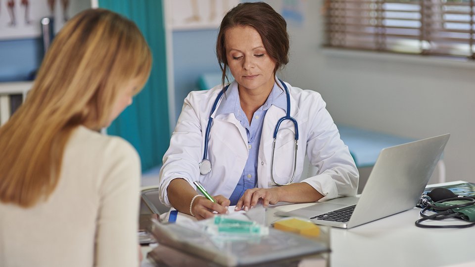 doctor-writing-prescription-her-patient