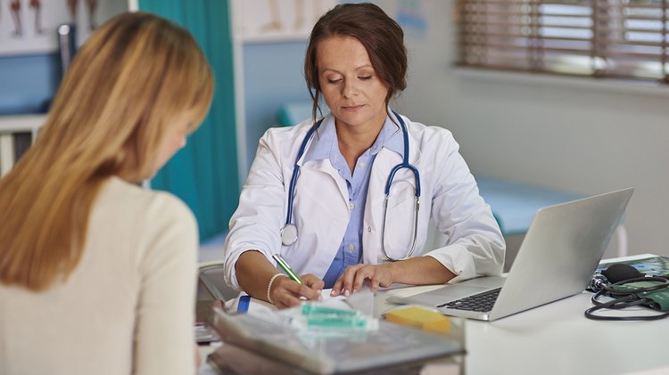 doctor-writing-prescription-her-patient