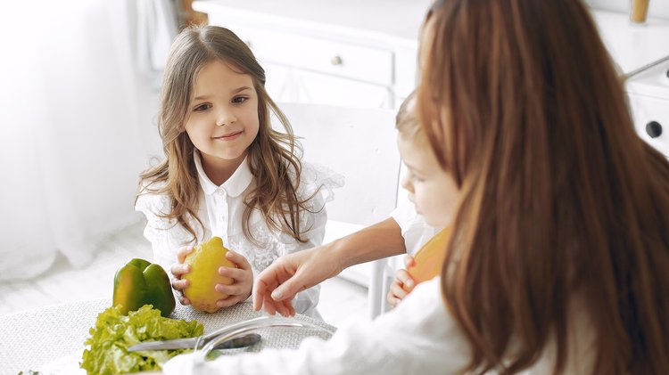 family-preparing-salad-kitchen
