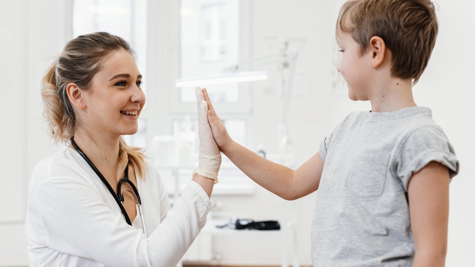 medium-shot-doctor-kid-high-fiving