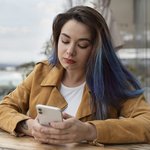 medium-shot-young-woman-sitting-coffee-shop