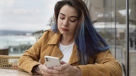 medium-shot-young-woman-sitting-coffee-shop