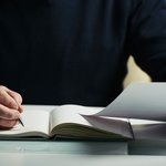 mid-section-unrecognizable-man-making-notes