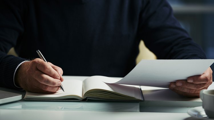 mid-section-unrecognizable-man-making-notes