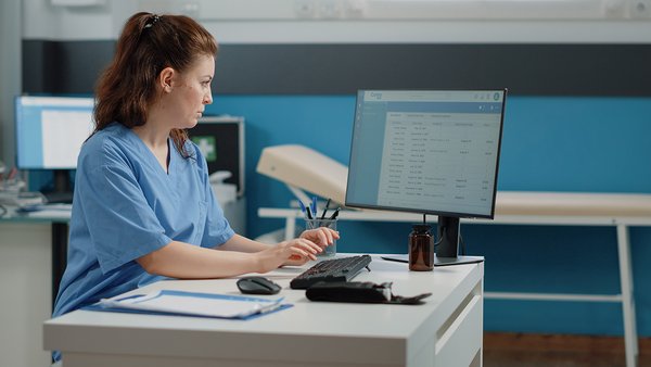 nurse-typing-computer-keyboard-consultation