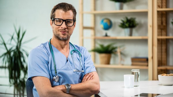 portrait-happy-confident-doctor-with-arms-crossed-medical-clinic