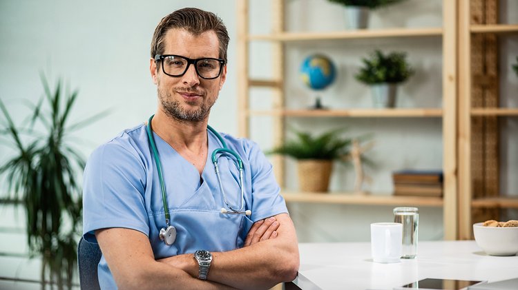 portrait-happy-confident-doctor-with-arms-crossed-medical-clinic