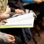 selective-focus-shot-person-holding-book