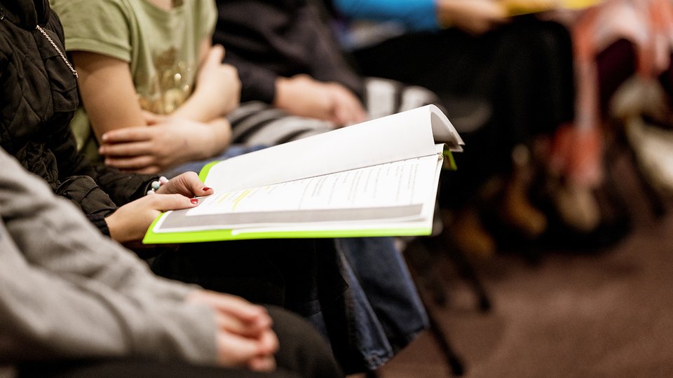selective-focus-shot-person-holding-book