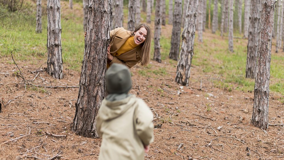 smiley-woman-hiding-tree-from-her-son