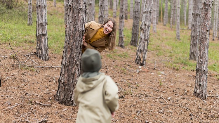 smiley-woman-hiding-tree-from-her-son