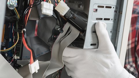 technician-hand-with-gloves-repairing-computer