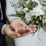 wedding-bands-hands-bride-groom-with-beautiful-wedding-bouquet-made-greenery-white-flowers